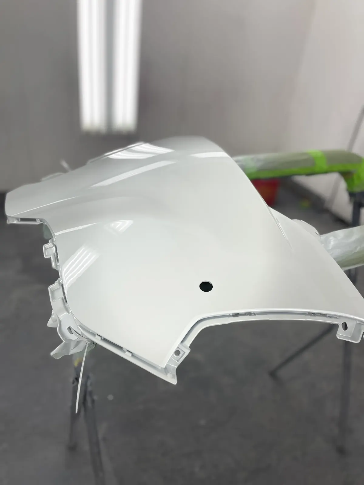 A vehicle panel being refinished at Drive Auto Body