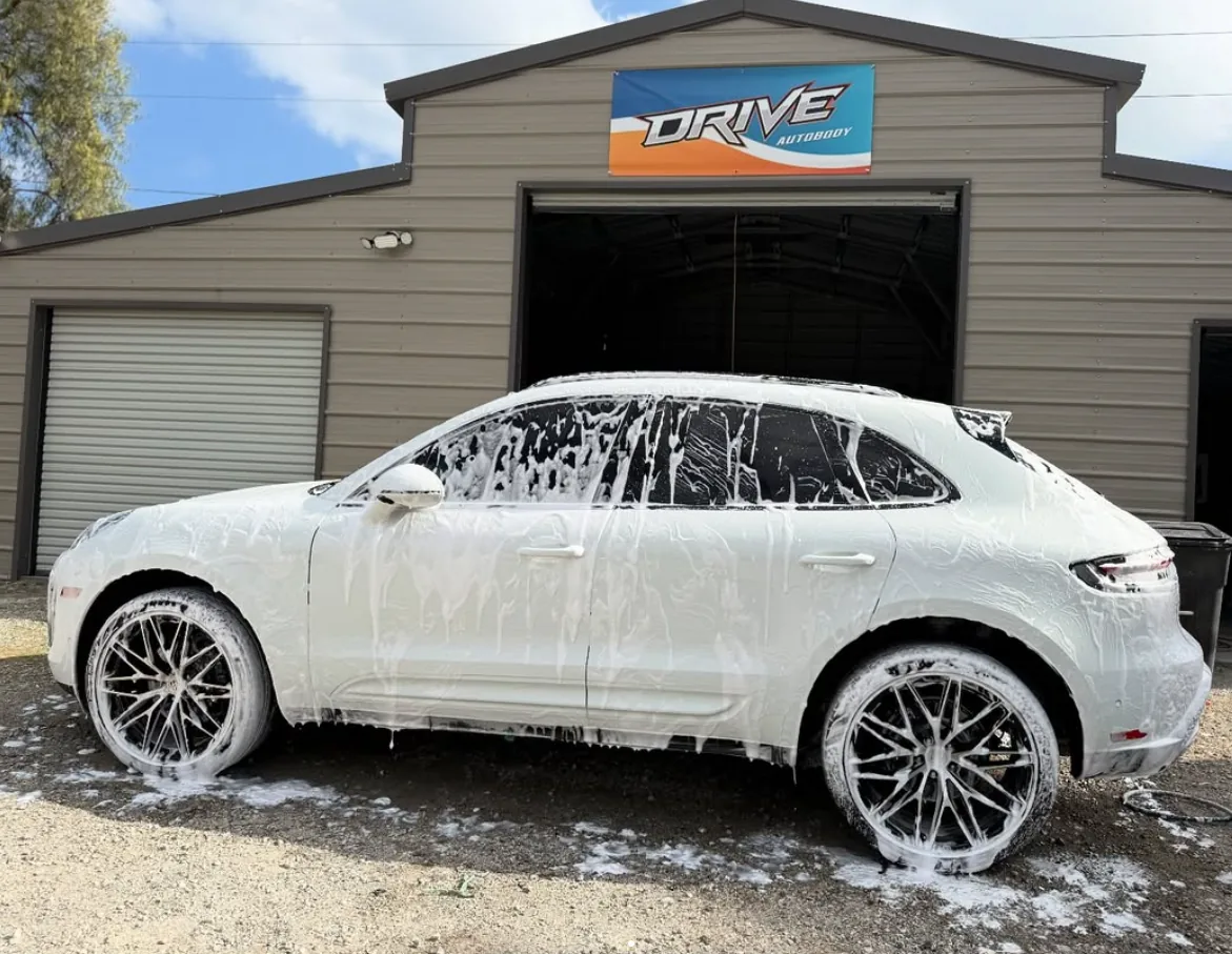 White Porsche Macan getting final wash and detail at Drive Auto Body Hemet — fast turnaround on every repair